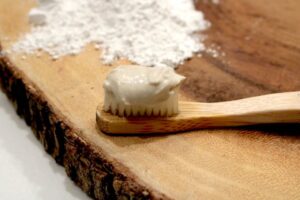This is an image of homemade toothpaste on a bamboo toothbrush.